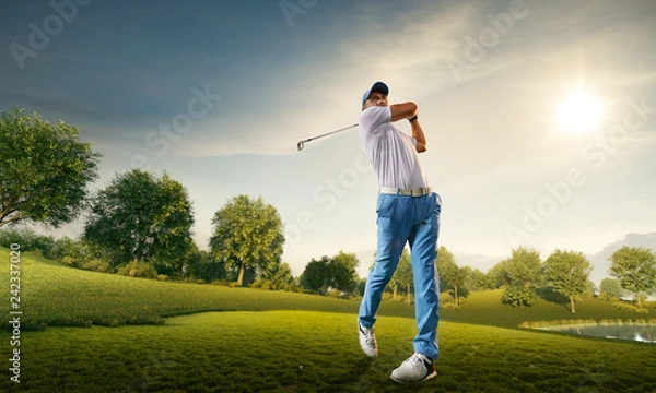 Fototapeta Male golf player on professional golf course. Golfer with golf club taking a shot