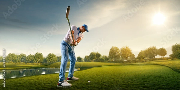 Obraz Male golf player on professional golf course. Golfer with golf club taking a shot