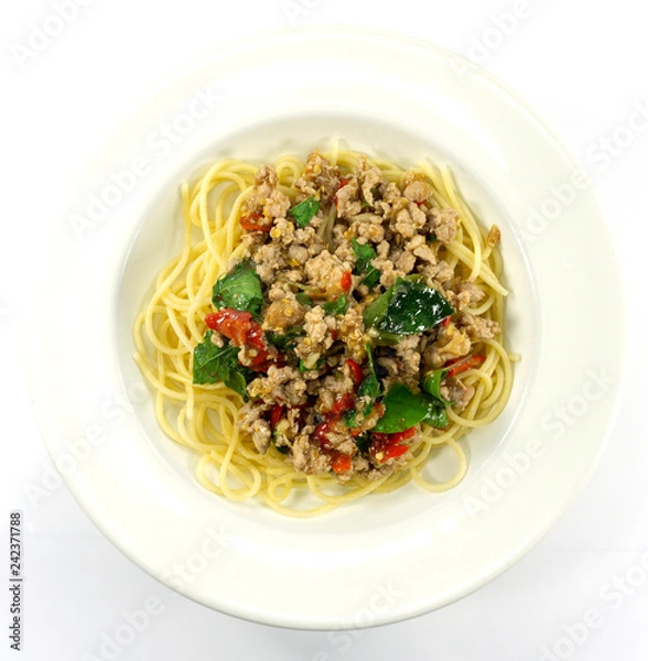 Fototapeta Spaghetti Fried Stir Basil with Minced pork in a dish white on floor table, ,food concept,Top view with copy space for your text.