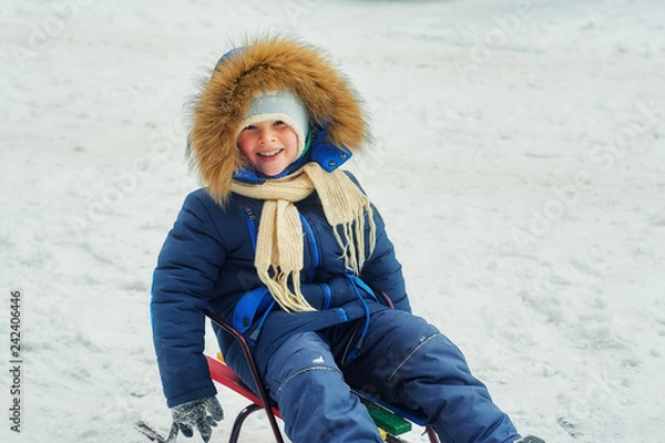 Fototapeta Winter portrait of a boy on a walk