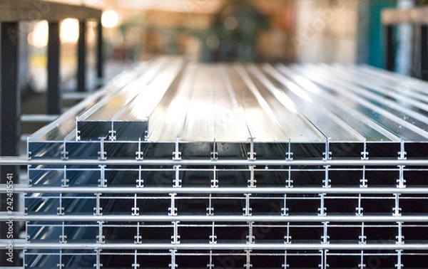 Obraz Aluminiun profiles placed in a row inside an aluminium profile factory.