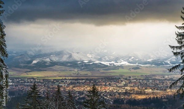 Fototapeta View of small town between mountains