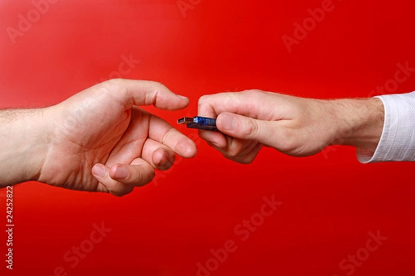 Fototapeta Man's hands with memory stick