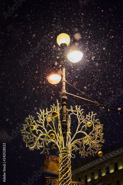 Obraz lamppost in the evening in the new year under