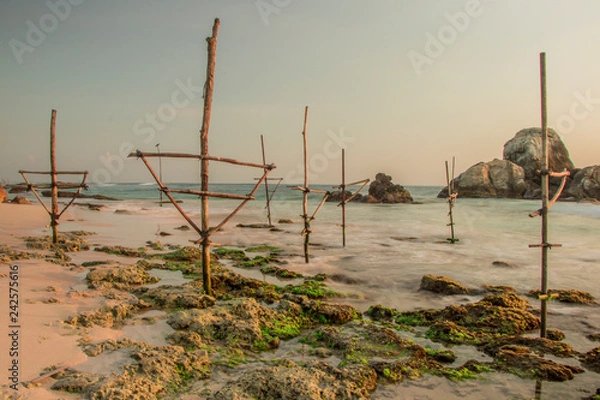 Obraz Long Exposure photography of Koggala Beach Sri Lanka with Coral Reefs and Fisherman Sticks