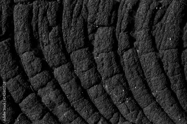 Fototapeta Black volcanic rock cooled to show a pretty pattern
