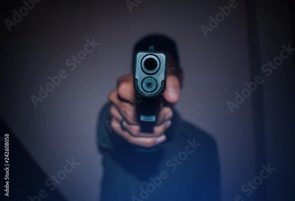 Obraz A man holding  gun in hand, the ship ready to shoot.A man is killer.