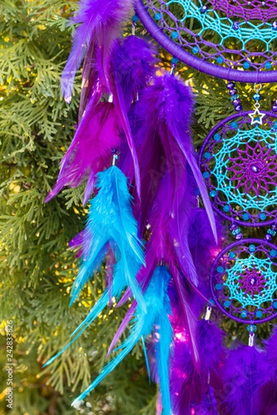 Fototapeta Handmade dream catcher with feathers threads and beads rope hanging