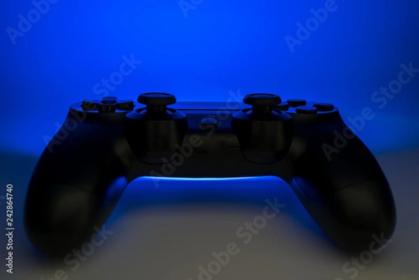 Fototapeta Video game controller with blue light emitting
