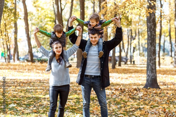Obraz Natural pictures of a happy family of four having fun outsiade on a sunny autumn day. Togetherness and happiness concept