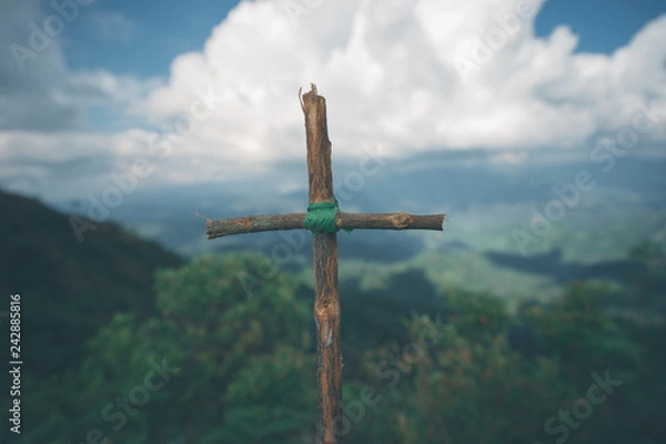 Fototapeta The cross with nature in the forest on the hill is the Blackground.