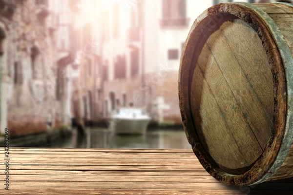 Fototapeta wooden barrel as a table with a free space for an advertising product, the hero on the background of the landscape  