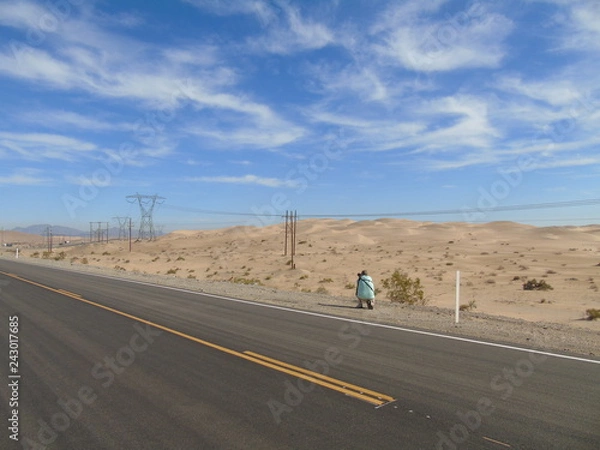Fototapeta Photographer taking pictures in the desert
