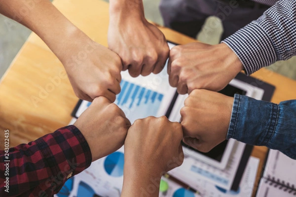 Obraz Teamwork of colleague assembly, Business team jointing putting fist together in circle as a connection meeting teamwork