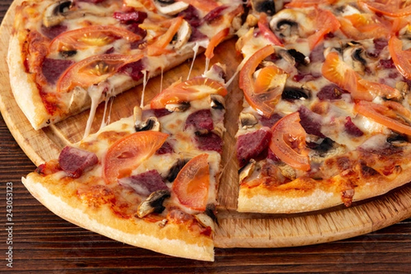 Obraz Bavarian pizza with sausages and mushrooms, juicy tomatoes and Parmesan
