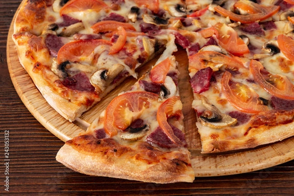 Obraz Bavarian pizza with sausages and mushrooms, juicy tomatoes and Parmesan