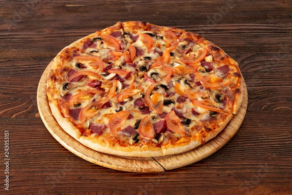 Obraz Bavarian pizza with sausages and mushrooms, juicy tomatoes and Parmesan