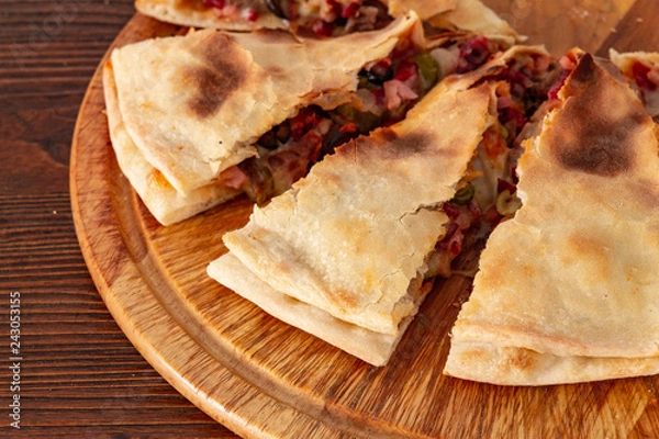 Obraz Pizza calzone on the textured table, for the restaurant menu, cafe, advertising.