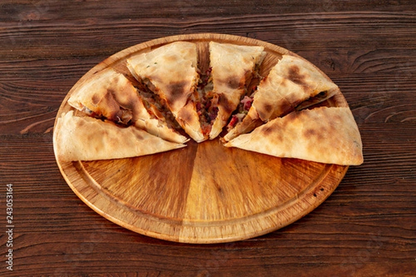 Obraz Pizza calzone on the textured table, for the restaurant menu, cafe, advertising.