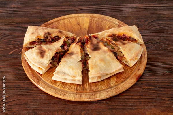 Obraz Pizza calzone on the textured table, for the restaurant menu, cafe, advertising.
