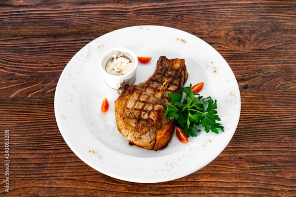 Obraz pork chop with vegetables in a white plate