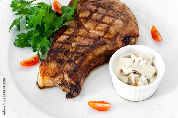 Obraz pork chop with vegetables in a white plate