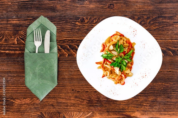 Obraz Chicken fricassee with mushrooms on a white plate with vegetables top view close-up with appliances