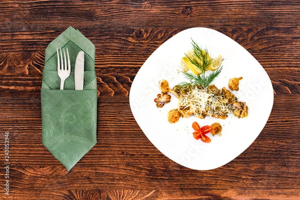 Obraz Seafood on a plate with appliances on a wooden table, a dish for the menu and advertising.