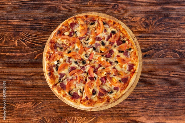 Obraz Bavarian pizza with sausages and mushrooms, juicy tomatoes and Parmesan