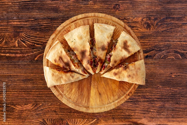 Obraz Pizza calzone on the textured table, for the restaurant menu, cafe, advertising.