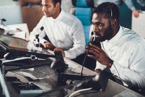 Fototapeta Young air dispatcher connecting on navigation board