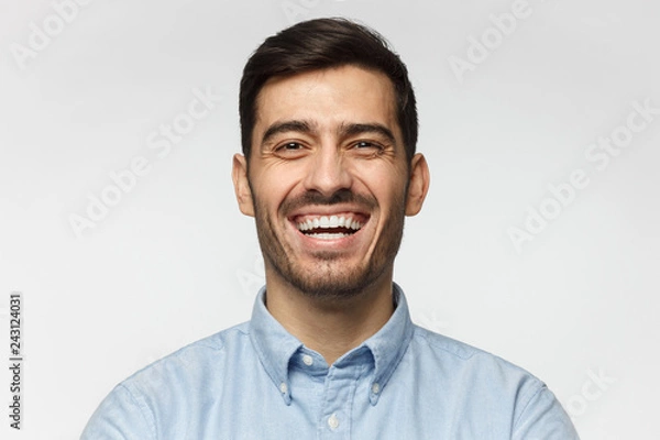 Obraz Portrait of handsome laughing business man, isolated on gray background
