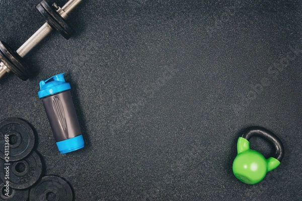 Obraz Fitness or bodybuilding concept background. Product photograph of old iron dumbbells on black grey, conrete floor in the gym. Photograph taken from above, top view with lots of copy space
