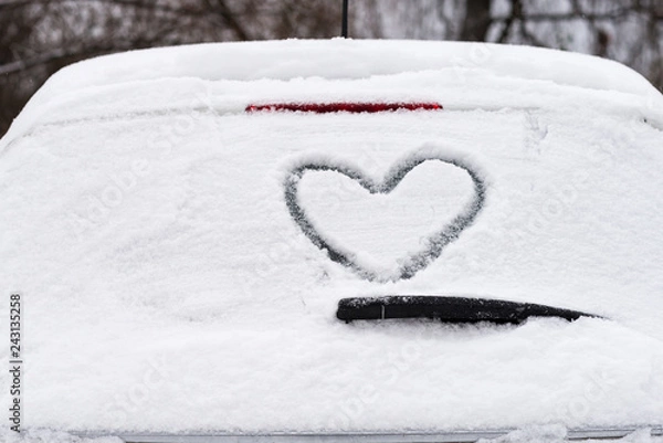 Obraz Closeup of heart shape on snow covered car rear window