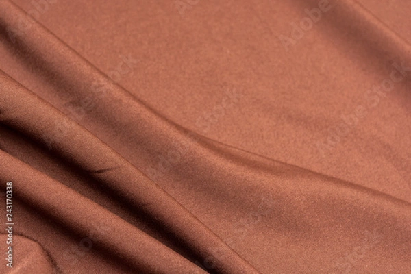 Fototapeta Texture of dark brown fabric closeup. Low key photo. Plexus threads. Clothing industry. Abstract background. Textile waves.