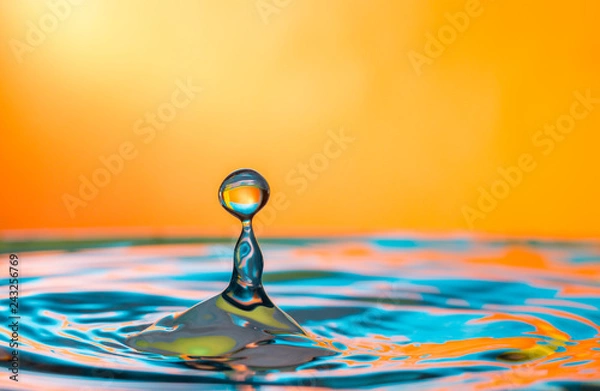 Obraz Water drop impacting a body of water