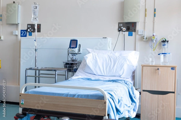 Fototapeta Empty bed in a hospital ward