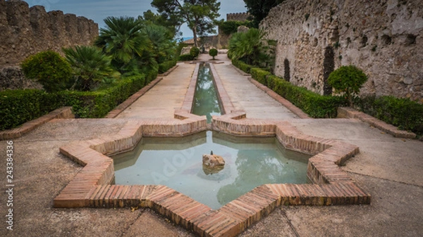 Obraz Moorish star shape fountain at Jativa / Xativa medieval castle in Valencia region on the Mediterranean coast in Spain. Moorish, Romans, and Christians castle built by King James I of Aragon.