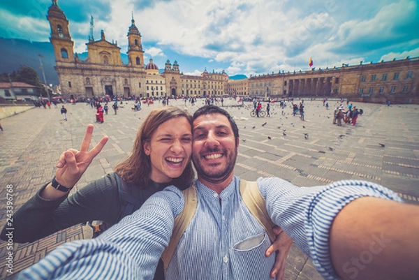 Fototapeta Happy young man taking a selfie photo in Bogota, Colombia. in the main square of the city called Bolivar square