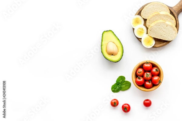 Fototapeta Sandwiches with avocado concept. Whole grain bread, half of avocado, guacamole on white background top view copy space