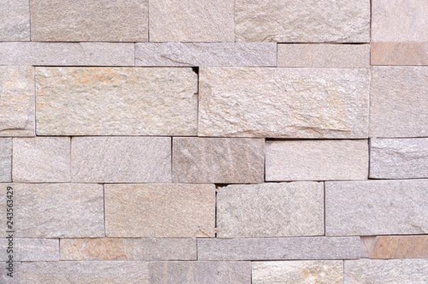 Fototapeta beige weathered stone tiled wall background. texture.