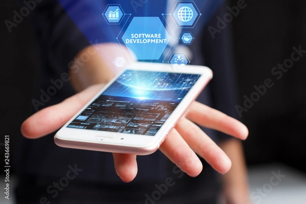 Fototapeta The concept of business, technology, the Internet and the network. A young entrepreneur working on a virtual screen of the future and sees the inscription: Software development