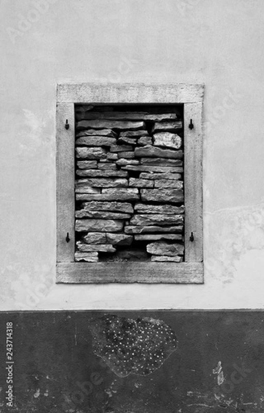 Fototapeta A window in a derelict building in the Croatian hill village of Bale, also called Valle. The window has been blocked with stones