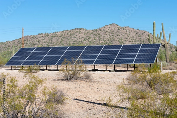 Fototapeta Solar panels on a hill side in the desert