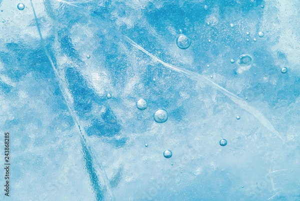 Fototapeta Abstract ice background. Blue background with cracks on the ice surface