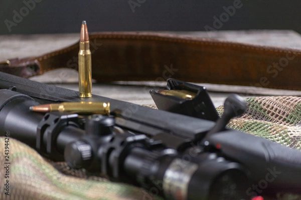 Fototapeta Rifle bolt action sniper weapon gun and ammo isolated on multicam background