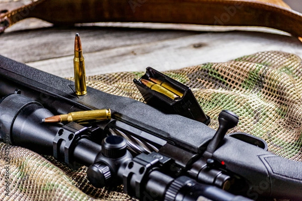 Fototapeta Rifle bolt action sniper weapon gun and ammo isolated on multicam background