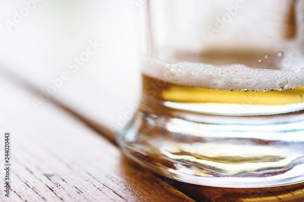 Fototapeta Empty Glass Of Cold Beer With Foam On Wooden Table