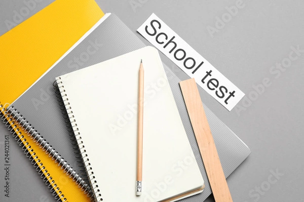 Obraz Stationery and paper with text SCHOOL TEST on grey background