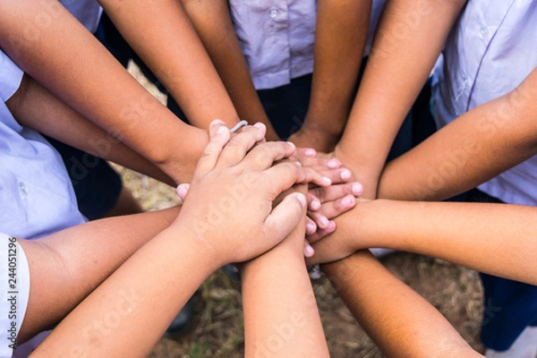Fototapeta School children use hand-to-hand coordination to combine power in activities.